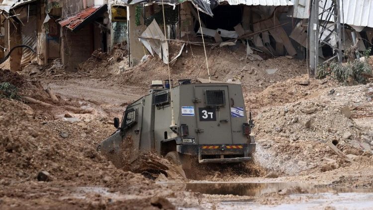 An Israeli military vehicle drives through the Jenin refugee camp during an operation on February 24, 2025