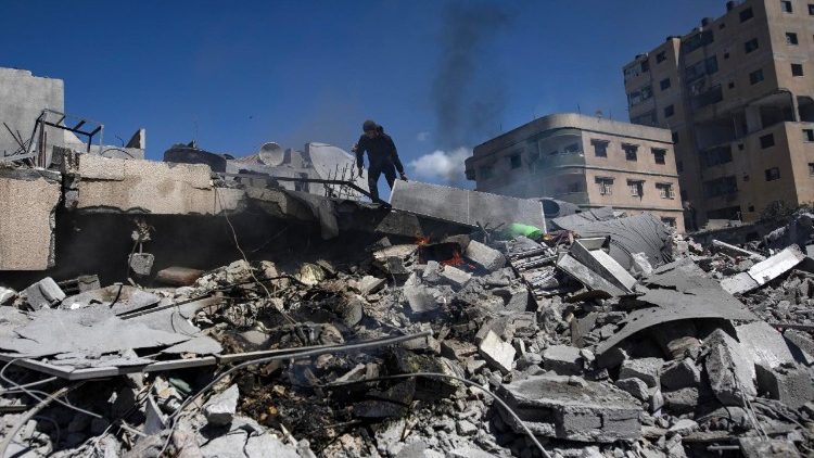 Palestinians inspect the rubble after renewed Israeli airstrikes on Gaza