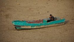 A man sits in abandoned boats in the bed of dried up reservoir on the outskirts of Sana'a, Yemen, 16 August 2025.