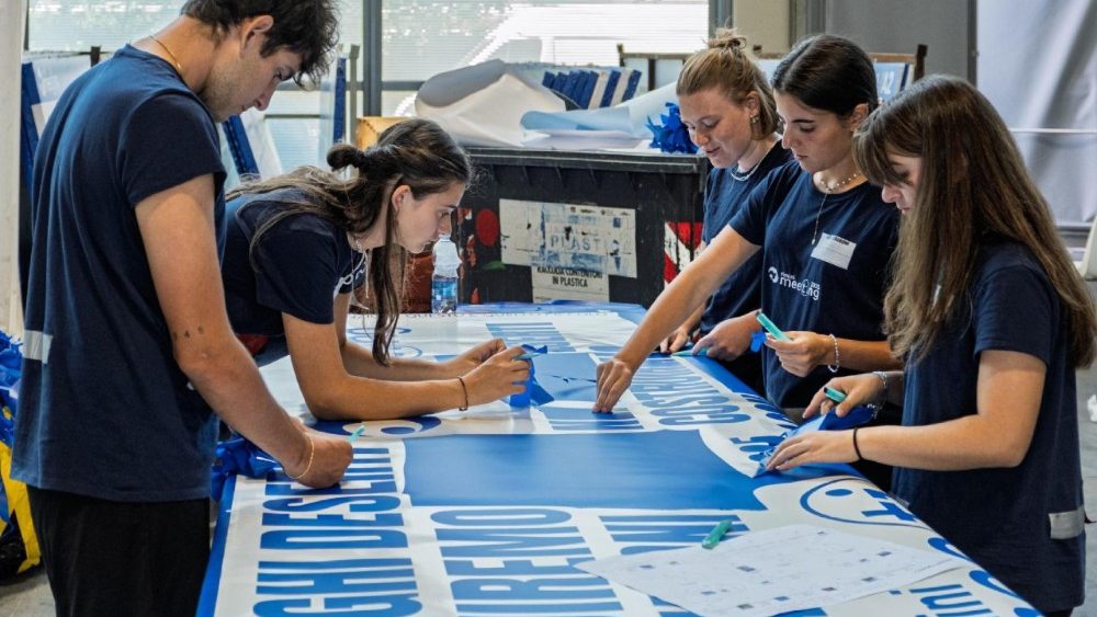 Giovani volontari al lavoro per la preparazione del Meeting dell'Amicizia tra i popoli, edizione 2025, alla Fiera di Rimini