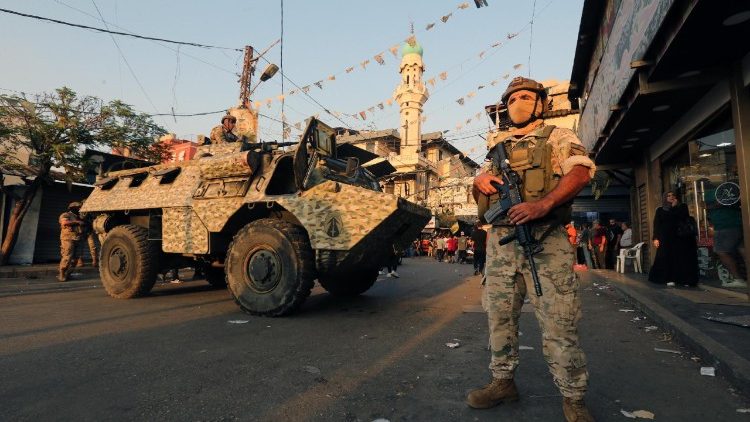Lebanese soldiers stand guard at the entrance of Burj Barajneh Palestinian refugee camp in southern Beirut, Lebanon