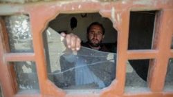 A resident of Afghanistan's Nangarhar province examines damage after alleged Pakistani airstrikes