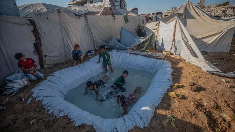 Displaced Palestinians endure summer heat at Gaza tent camp