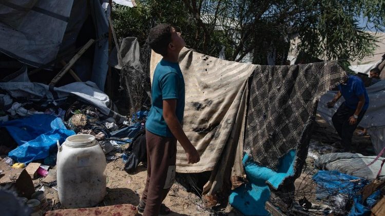 Displaced Palestinians inspect site of Israeli strike in Al-Mawasi