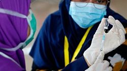 A medical worker prepares a dose of a Covid-19 vaccine in Jakarta