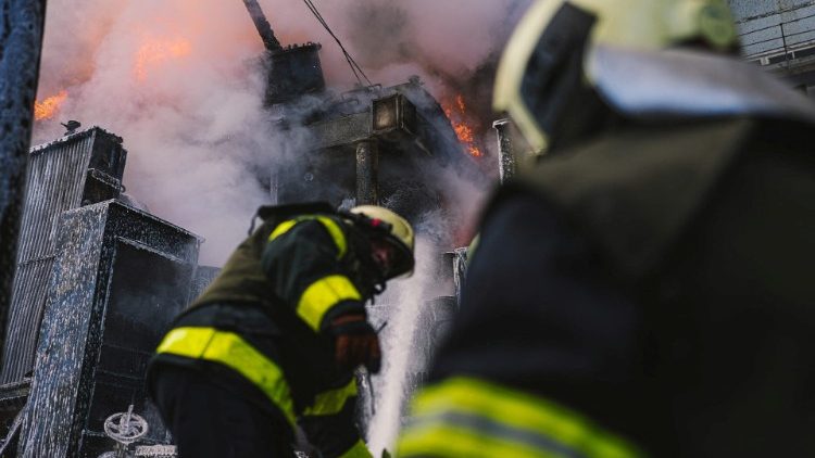 Firefighters work to put out a fire in a thermal power plant, damaged by a Russian missile strike in Kyiv
