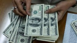 FILE PHOTO: Employee counts U.S. dollar at money changer in Jakarta