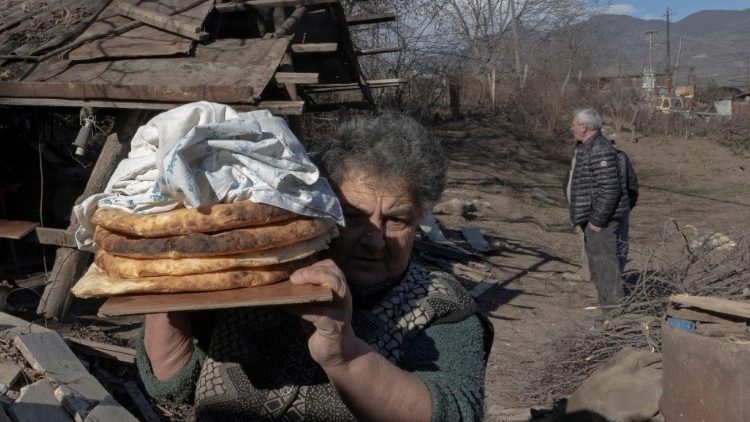 FILE PHOTO: Local resident Zina Fatyan carries freshly baked bread in divided Taghavard village in Nagorno-Karabakh region