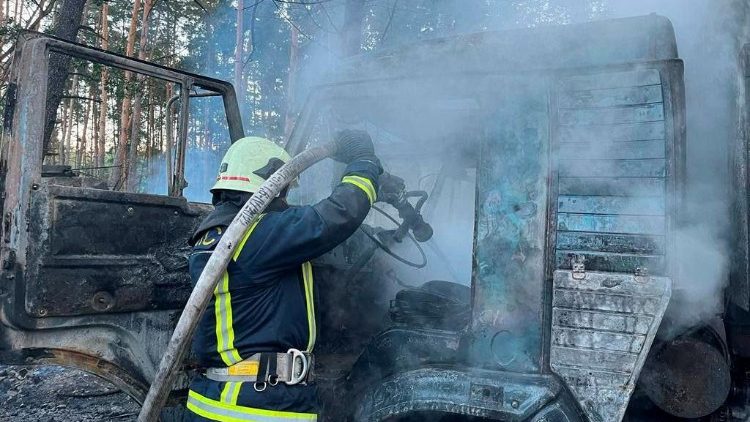 Firefighters work at a site which was hit during Russia's missile attacks in Kyiv region