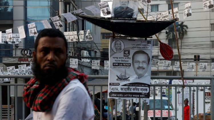 A man looks on as an installation of a boat, the voting symbol of Bangladesh Awami League is placed on a road divider ahead of general election in Dhaka