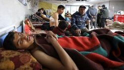 Palestinians wounded in Israeli fire while waiting for aid, according to health officials, lie on beds at Al Shifa hospital, amid the ongoing conflict between Israel and Hamas, in Gaza City