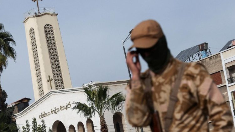 A rebel fighter guards on the street in front of a church in Damascus, 3 days from the fall of Assad