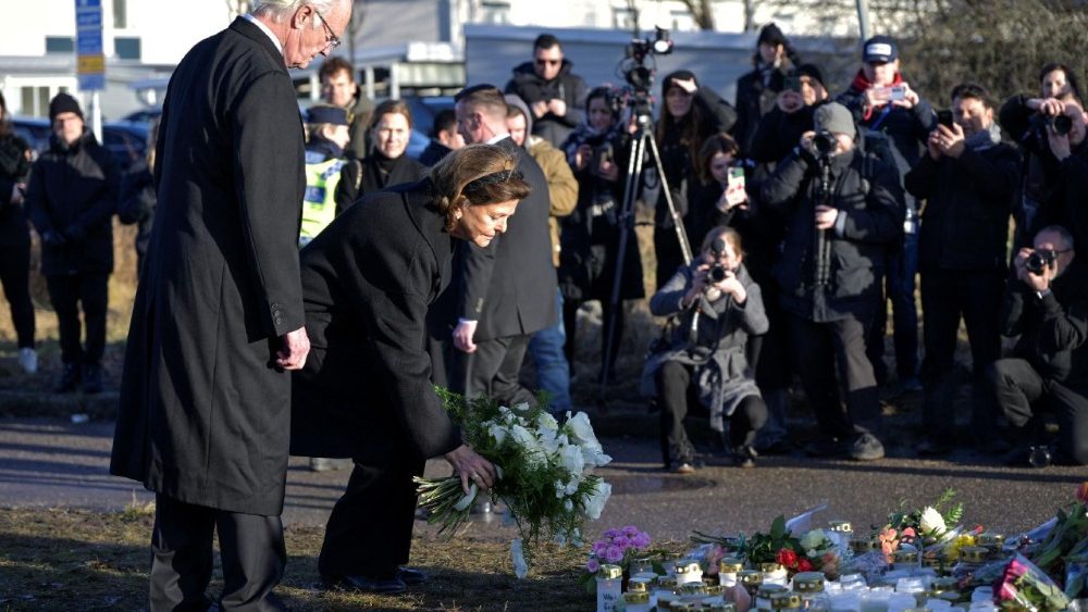 Sweden's King Carl Gustaf and Queen Silvia visit the memorial site where mourners placed candles and flowers outside Campus Risbergska School in Orebro