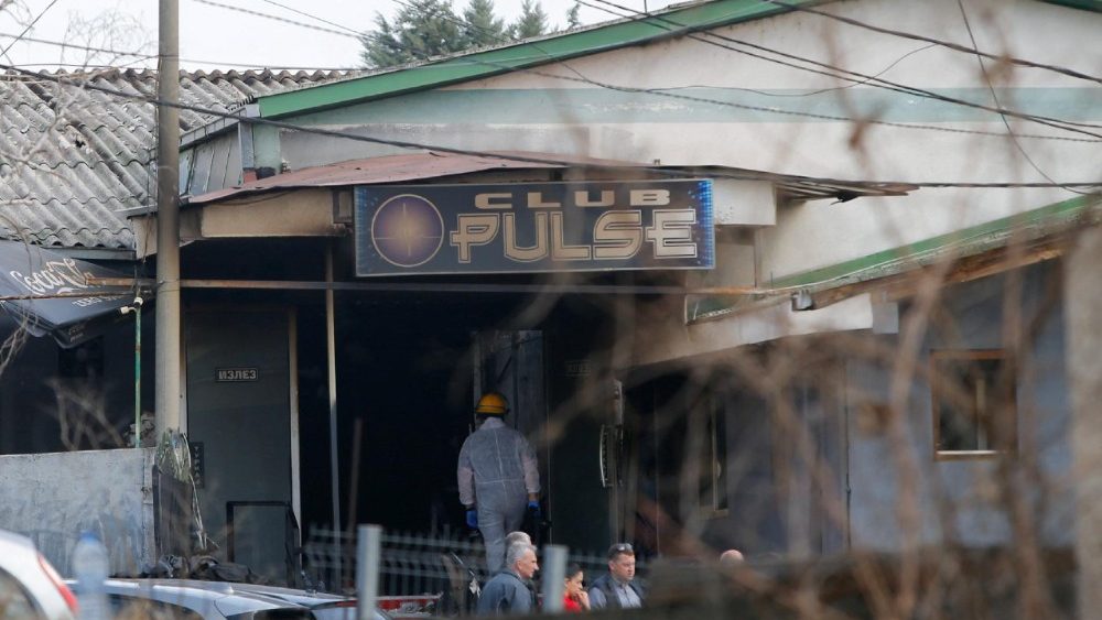Rescue crews operate outside a night club, following a fire resulting in casualties, in the town of Kocani