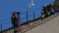 Members of the fire and rescue service set a chimney on the roof of the Sistine Chapel, ahead of the conclave, at the Vatican