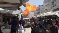 Smoke and flames rise from a house hit by an Israeli strike in Gaza City