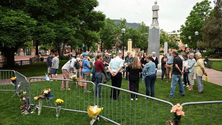People pray near the scene of the attack in Boulder, Colorado, USA.