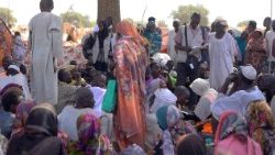 Displaced Sudanese gather and sit in makeshift tents after fleeing Al-Fashir city in Darfur