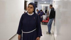 Director of De La Croix Hospital, sister Rose Hanna, walks near patients inside the Notre Dame pavilion at De La Croix Psychiatric Hospital in Jal el-Dib