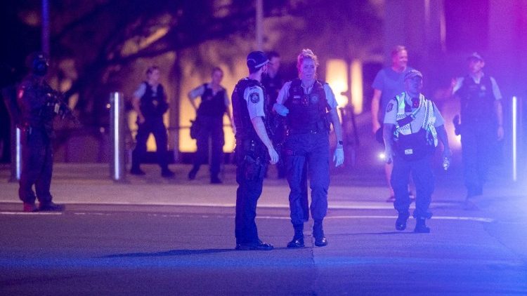 Police officers walk on the street following a shooting incident at Bondi Beach, in Sydney