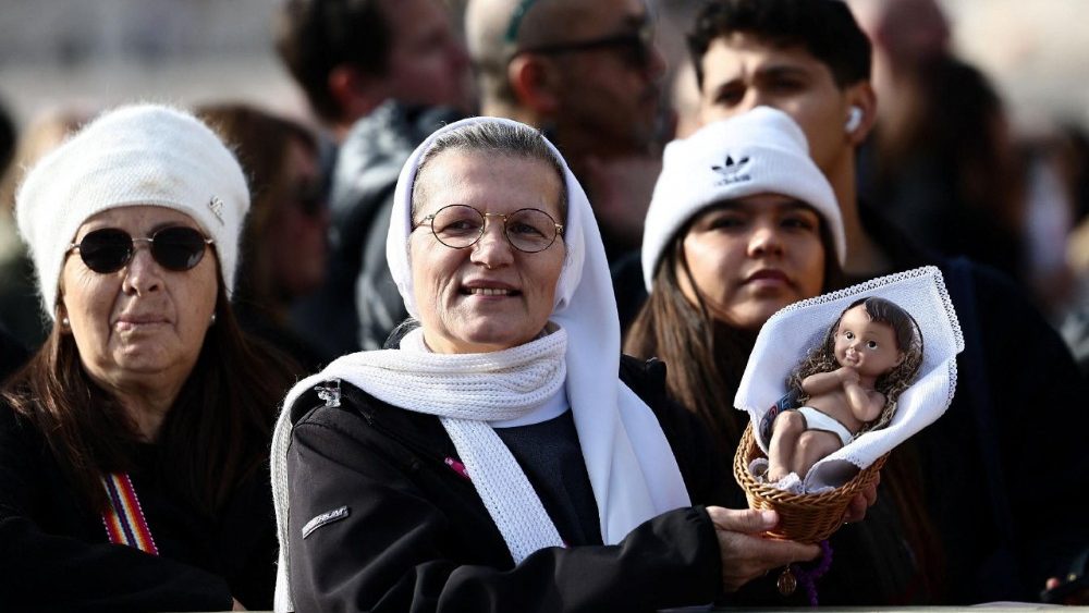 Nun holds baby Jesus figurine before receiving a blessing, at the Vatican