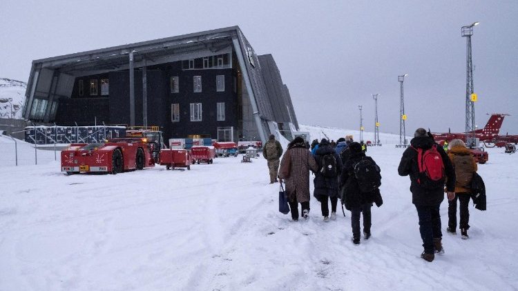 FILE PHOTO: Passengers walk on the tarmac as they arrive at Nuuk International Airport in Greenland