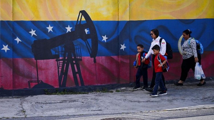 FILE PHOTO: People walk past a painting of an oil pump on Venezuela's national flag, in Caracas