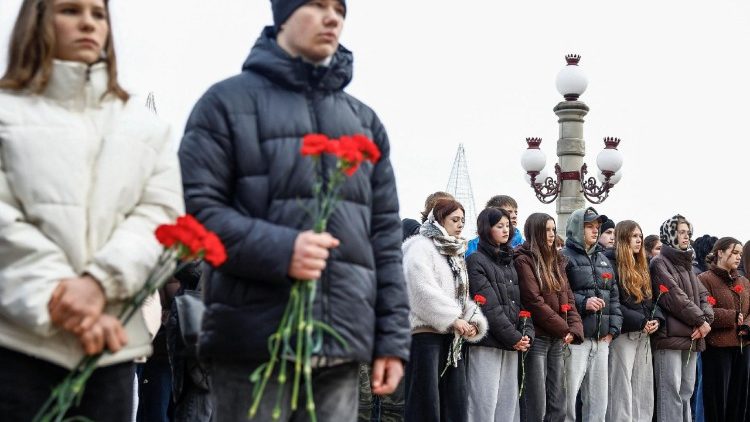 People gather to mark the fourth anniversary of the full-scale Russian invasion in Irpin