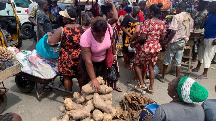 FILE PHOTO: People shop at a fresh food market in Oyingbo, Lagos