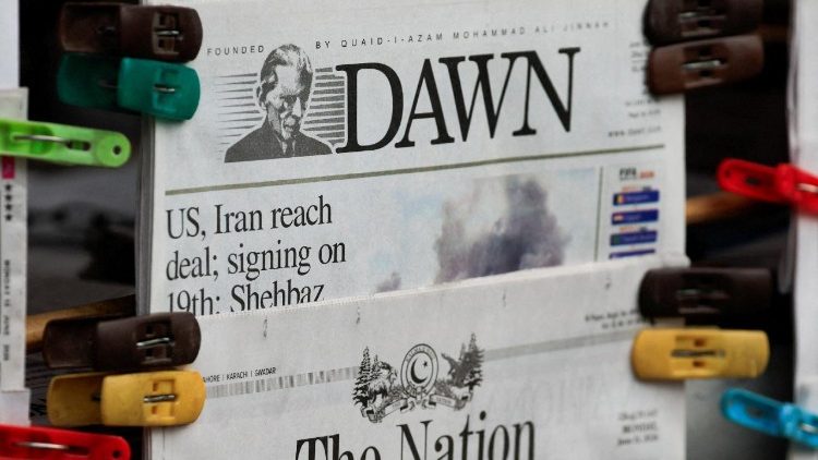 A newspaper displays coverage of the U.S.-Iran peace deal signing, at a newsstand in Islamabad