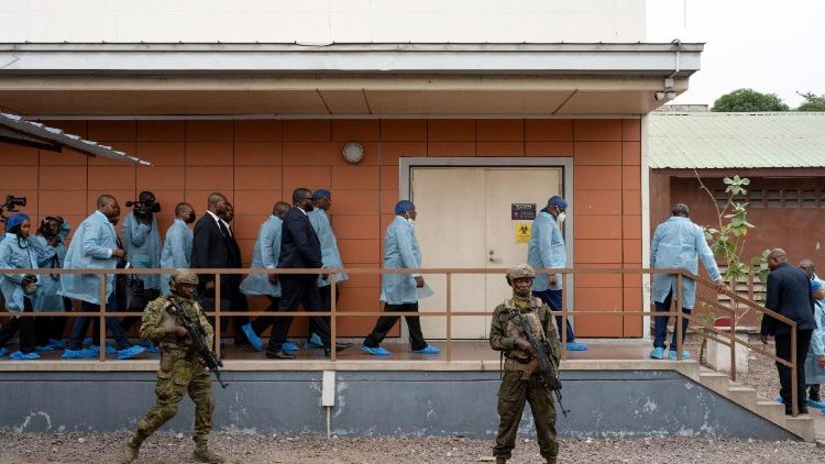 Il presidente sudafricano Cyril Ramaphosa e il presidente della Repubblica Democratica del Congo Felix Tshisekedi, con indosso indumenti protettivi, camminano con altri funzionari durante una visita all'Istituto Nazionale di Ricerca Biomedica a Kinshasa, Repubblica Democratica del Congo