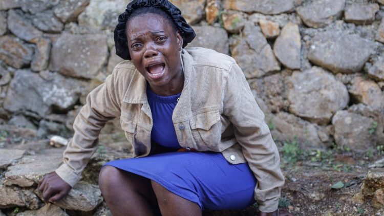 Uma mulher chora perto dos corpos de pessoas mortas durante um ataque noturno de um grupo armado, nos arredores de Porto Príncipe, em Kenscoff, Haiti, em 24 de agosto de 2026. REUTERS/Patrice Noel