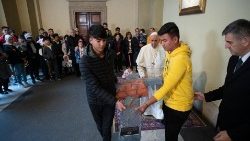 Pope Francis blesses the cross adorned with a lifejacket which would later be placed in his apartment in the Vatican