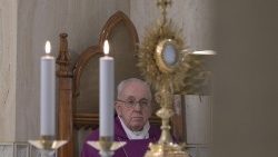 Pope Francis prays at Mass in the Casa Santa Marta