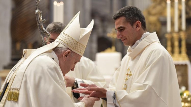 File photo of Pope Francis with a newly-ordained priest