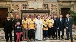 Pope Francis poses for a photo with his football team