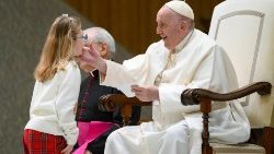 Pope Francis greets a girl from the Pope John XXIII Community