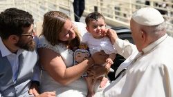 File photo of Pope Francis with a family at a General Audience