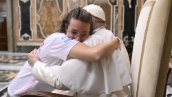 Pope Francis hugs a young lady from Argentina