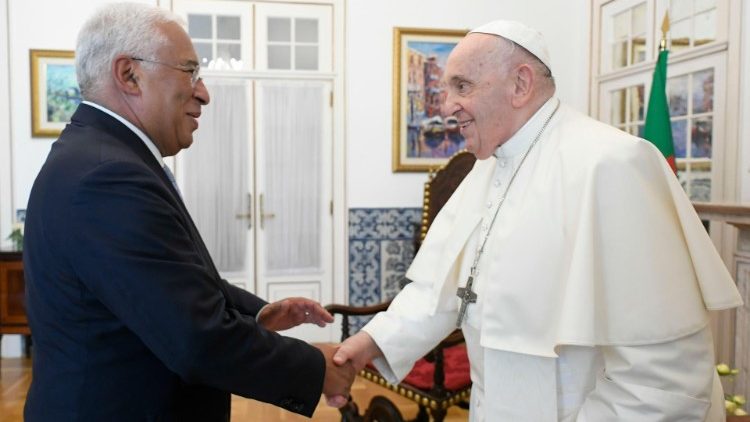 Pope Francis shakes hands with Portugal's Prime Minister António Costa