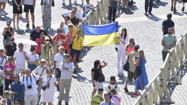 Alcuni fedeli in piazza San Pietro con la bandiera ucraina