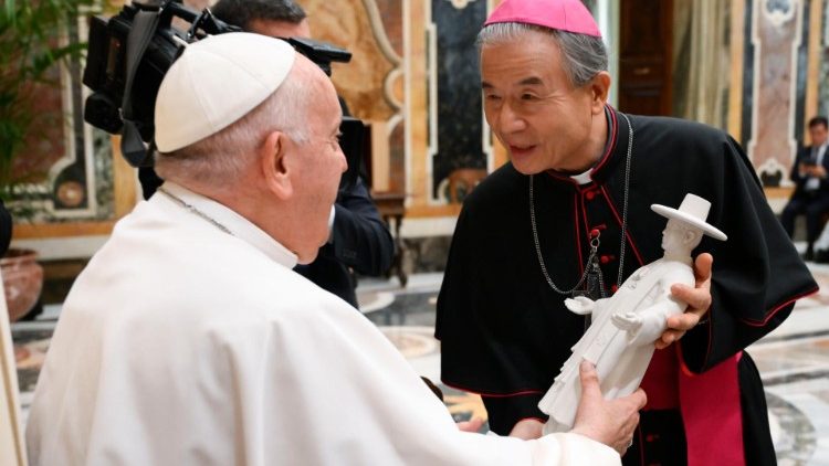 Pope Francis holds a miniature statue of St. Andrew Kim Taegon