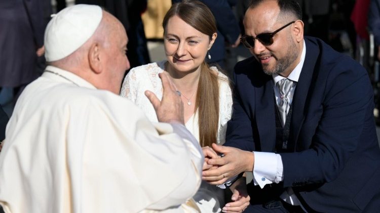 Pope Francis blesses a pair of newlywed Vatican employees