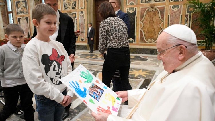 Pope Francis receives a handmade painting from a child