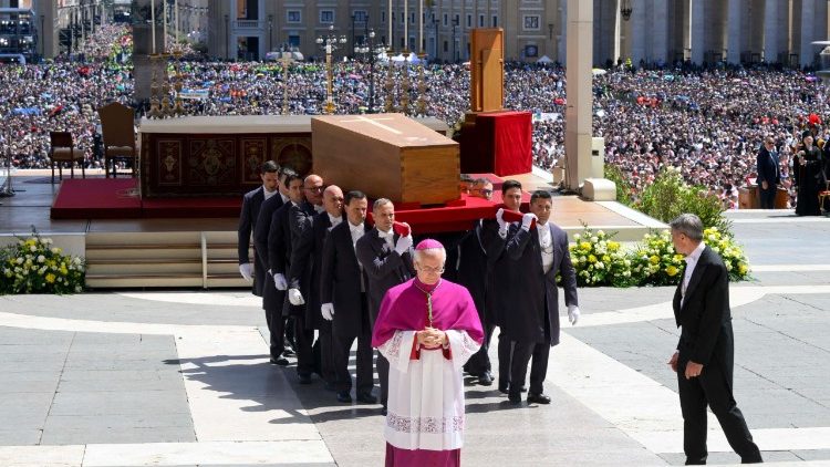 Pall bearers carrying the casket out of the Basilica