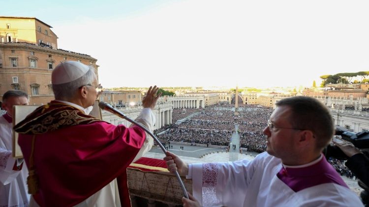 Newly elected Pope Leo greets the crowds from the central balcony of St. Peter's Basilica