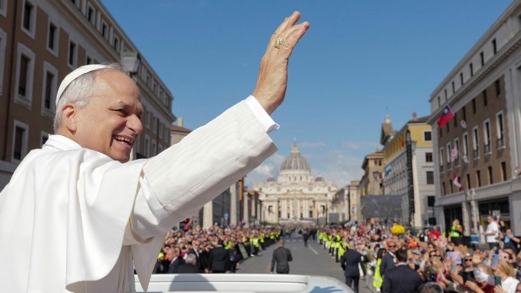 Pope Leo waves to the crowd on the Via della Conciliazione after Mass on May 18, 2025