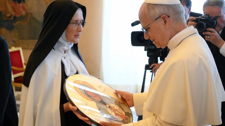 Pope Leo receives a gift from one of the participants in the audience