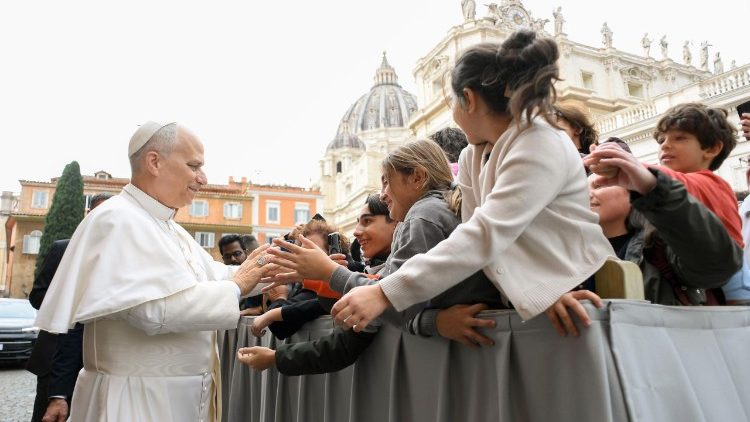 Leone XIV mentre si sofferma con alcuni ragazzi nel cortile del Petriano