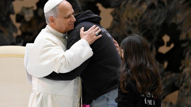 Pope Leo embraces a young man